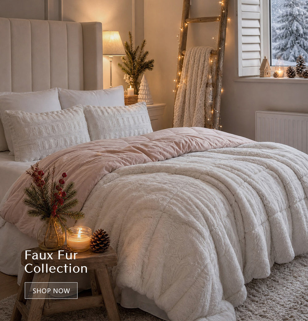 Faux Fur Collection homepage banner. Gia faux fur comforter set in blush/white, brushed long-fur face with faux mink reverse, hypoallergenic fill, OEKO-TEX certified. Links to faux fur bedding & accessories collection page.